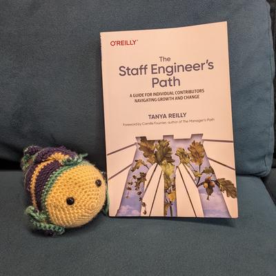 The book sits next to a crocheted fish